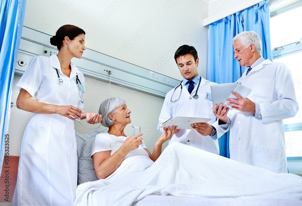 Obraz premium Hospital, bed and doctors with old woman, explaining and communication for health of patient and medical. Clinic, wellness and nurse with senior person, water and document with test in appointment