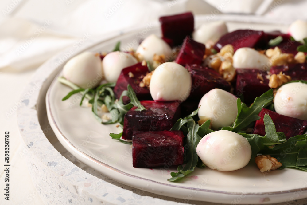 Plate of fresh salad with beet and mozzarella cheese on white background, closeup Plate of fresh salad with beet and mozzarella cheese on white background, closeup