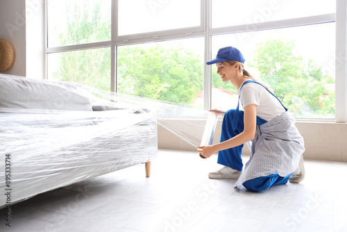 Female worker wrapping couc...