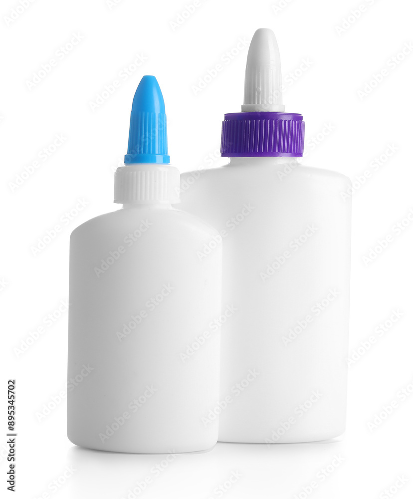 Bottles of glue on white background