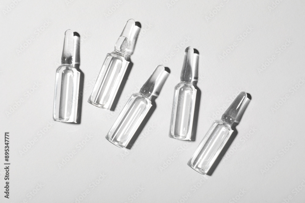 Glass ampules on grey background Glass ampules on grey background