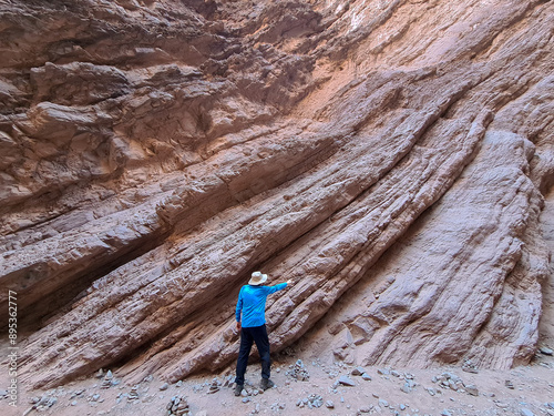 Geologist explaining the stratified and folded sedimentary rocks in northern Argentina photo