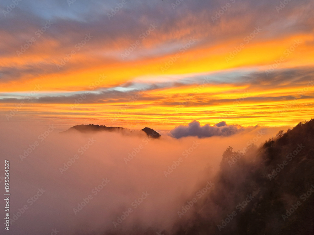 Fototapeta premium Beautiful cloudy sunset landscape view with horizon mountains.