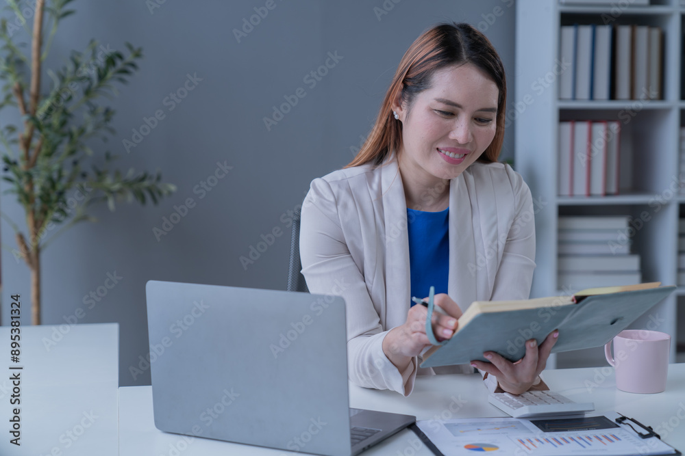 Bussiness women using laptop and smartphone working in the office Bussiness women using laptop and smartphone working in the office