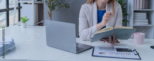 Bussiness women using laptop and smartphone working in the office 