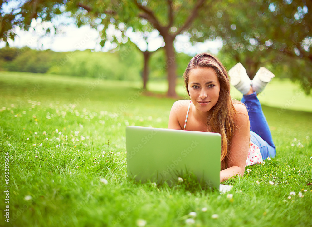 Relax, laptop and portrait of woman in park for online learning, internet and university website on grass. College, education and person on computer for studying, research and project in nature Relax, laptop and portrait of woman in park for online learning, internet and university website on grass. College, education and person on computer for studying, research and project in nature