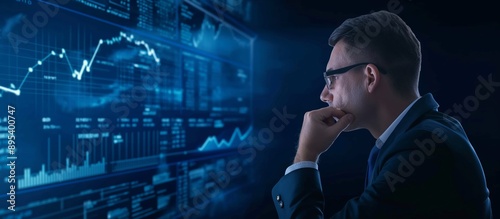 Business Analyst Reviewing Financial Data on Digital Screen in Dark Room