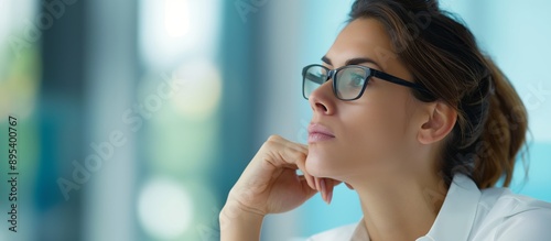 Pensive Businesswoman in Modern Office Setting Contemplating Business Strategies