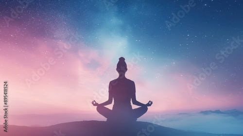 A woman is meditating in a field at night