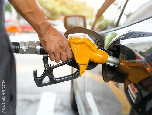 A person hand pumping gasoline fuel or fueling car at gas station. Fuel station service fill energy