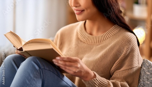 Firefly Reading Concept. Soft Focus of Young Woman Relaxing by Book and Coffee in Cozy House, Sit on