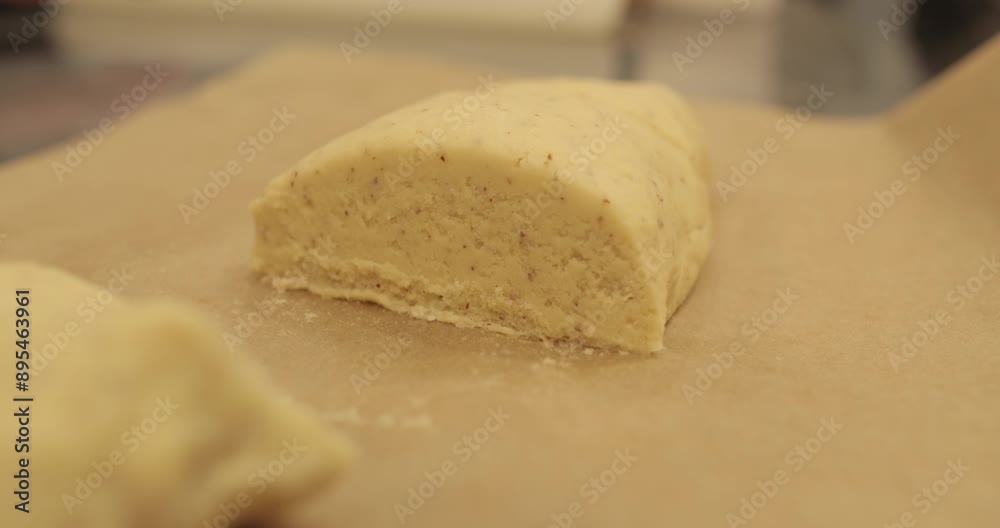 Kneading-preparation of dough for tarts. The chef kneads the dough with his hands on the kitchen table. Female hands preparing dough on a metal table Kneading-preparation of dough for tarts. The chef kneads the dough with his hands on the kitchen table. Female hands preparing dough on a metal table