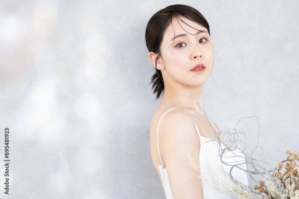 Image of a smiling bride holding a bouquet of flowers Looking at the camera with an image of ennui Image of a smiling bride holding a bouquet of flowers Looking at the camera with an image of ennui