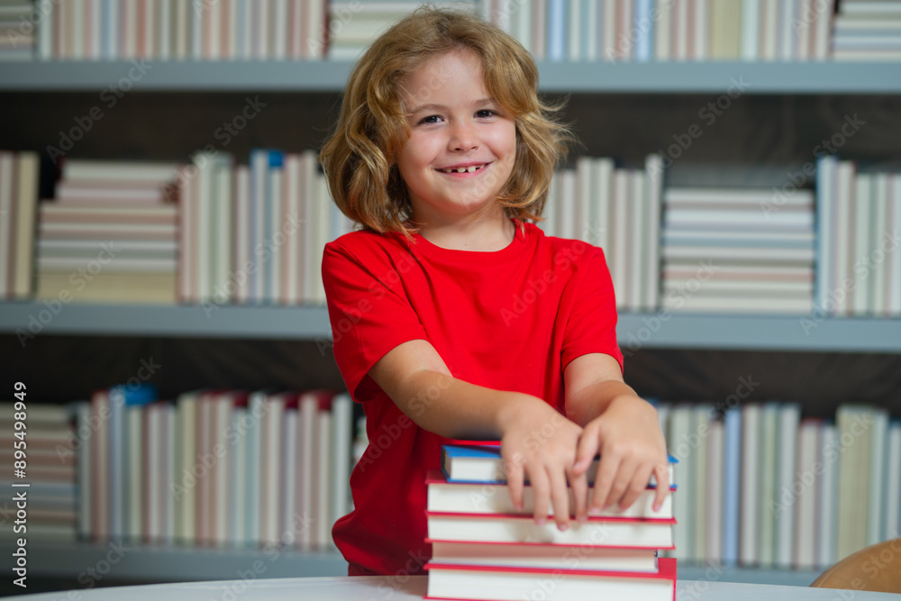 Happy school kid. Kids education and school concept. Portrait of school boy pupil reading book in library. Kids development, learn to read. Child reading books in a book store. Happy school kid. Kids education and school concept. Portrait of school boy pupil reading book in library. Kids development, learn to read. Child reading books in a book store.