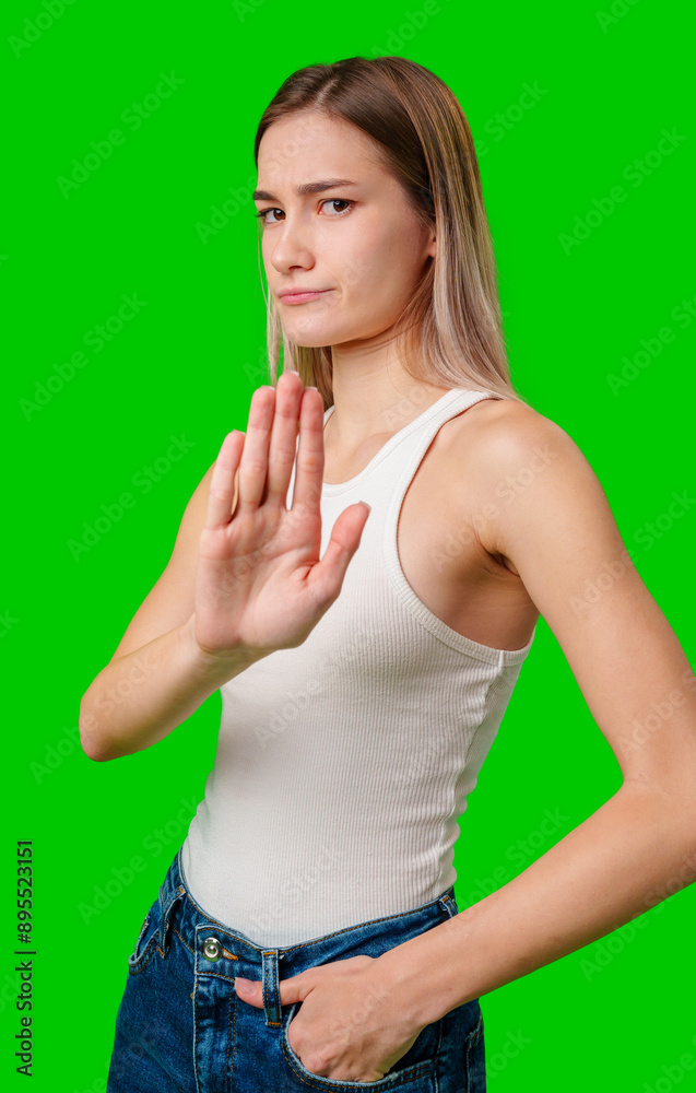 Young Woman In White Tank Top Making Stop Gesture On Green Screen