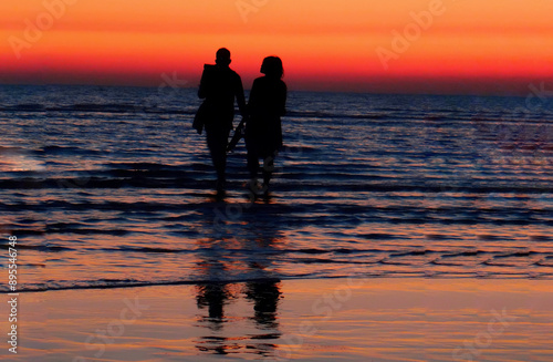 happy couple walking on the beach