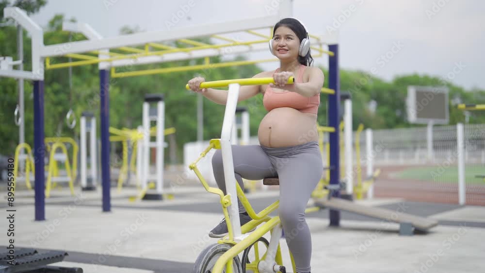 A portrait of happy Asian pregnant woman at gym fitness center club. Having a baby. Training workout. Exercise indoor with sport equipment. Athletic. Family people lifestyle. Mom love. Recreation. A portrait of happy Asian pregnant woman at gym fitness center club. Having a baby. Training workout. Exercise indoor with sport equipment. Athletic. Family people lifestyle. Mom love. Recreation.