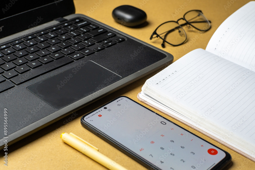 Office workplace with laptop, smart phone and glasses on wooden table Office workplace with laptop, smart phone and glasses on wooden table
