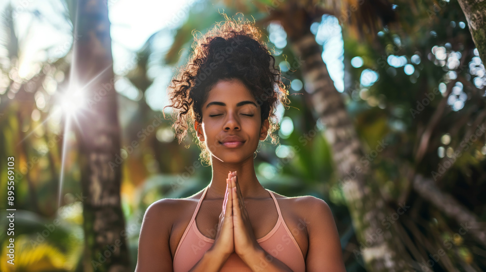 Woman practicing yoga in a tropical forest setting Woman practicing yoga in a tropical forest setting