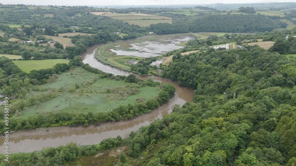 Aerial view of the river Tamar meandering through the picturesque countryside of Devon and Cornwall, highlighting the lush landscapes and natural beauty Aerial view of the river Tamar meandering through the picturesque countryside of Devon and Cornwall, highlighting the lush landscapes and natural beauty