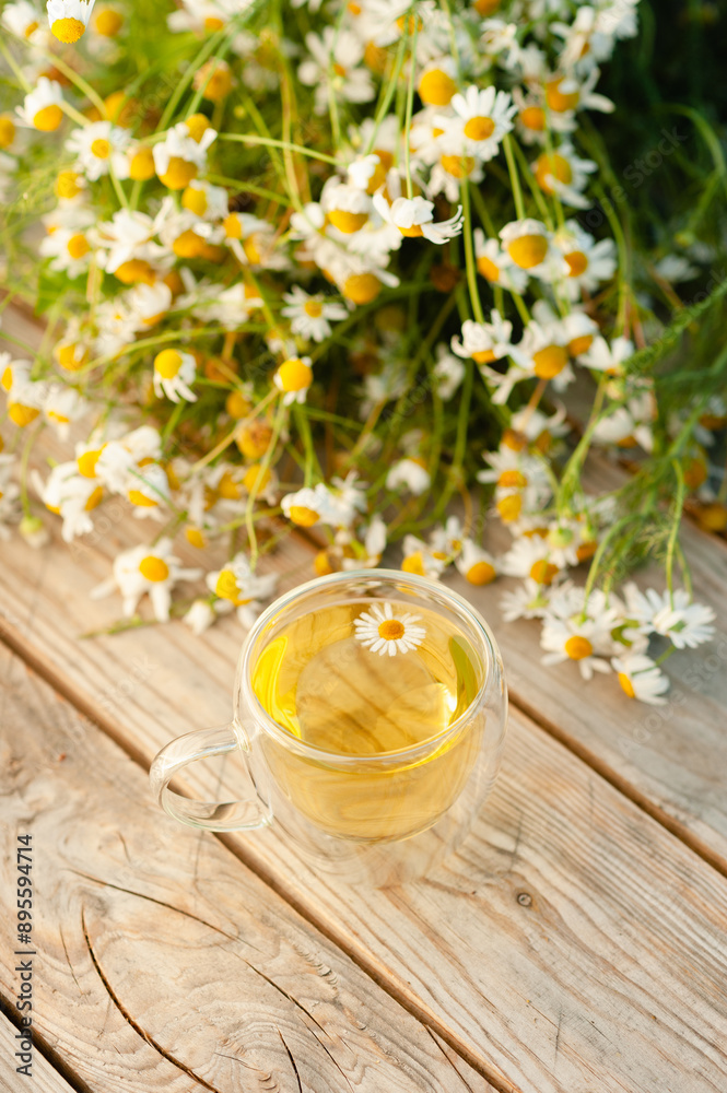 A cup of chamomile tea on a wooden table. A cup of chamomile tea on a wooden table.