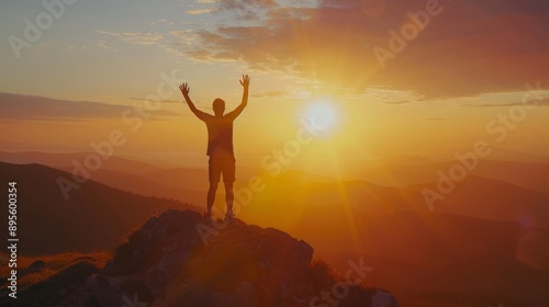 Silhouette of man standing on top mountain with arms raised up and looking at sky during sunset Concept for success achievement or determination in business