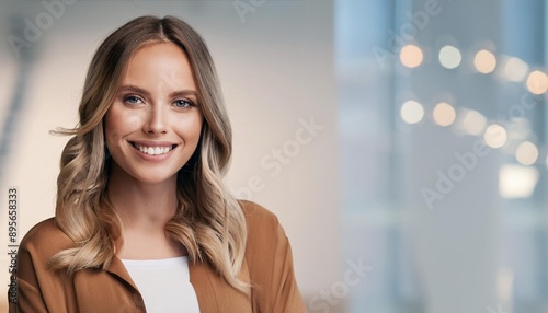 A cheerful woman with long hair smiling in a modern, softly lit environment, exuding warmth and professionalism. Free Download A cheerful woman with long hair smiling in a modern, softly lit environment, exuding warmth and professionalism. - GFXLoad