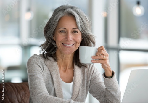 Woman Drinking Coffee at a Desk