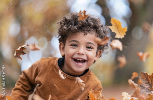 Smiling Child in Autumn Leaves