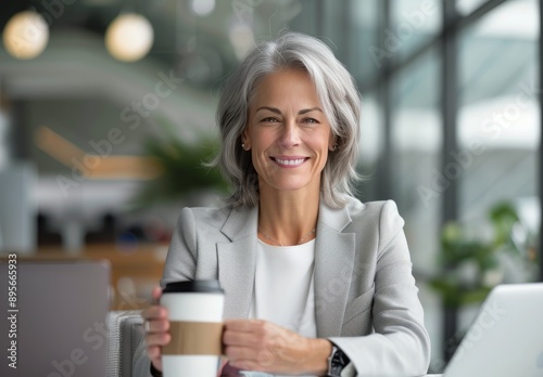 Woman Drinking Coffee at a Desk