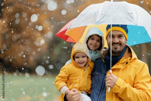 Father And Daughter Under Umbrella In Rain