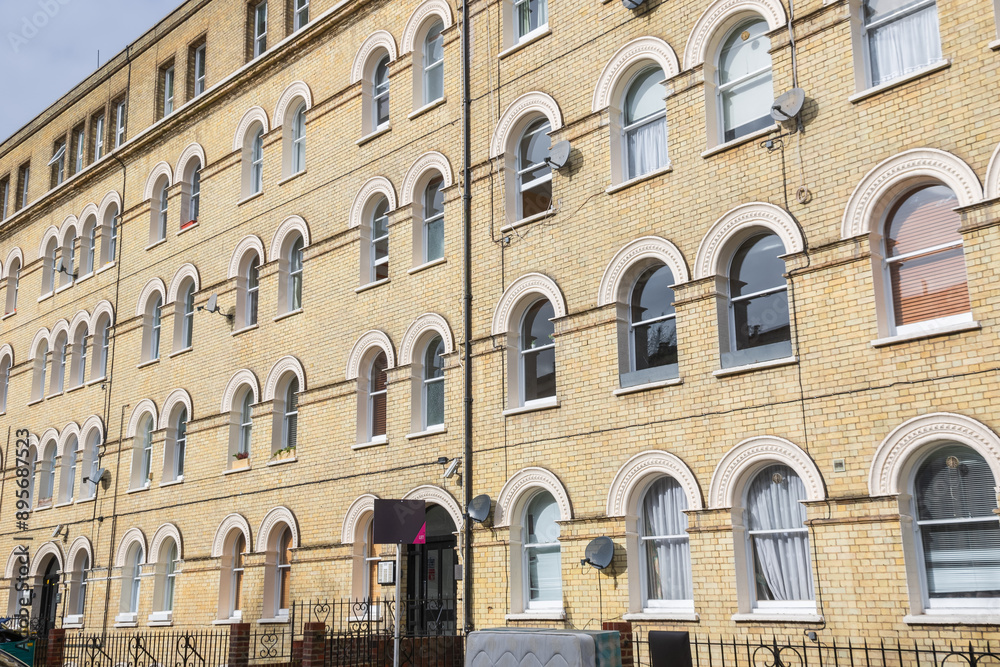 Facade of Georgian style apartment with arched windows in London Facade of Georgian style apartment with arched windows in London