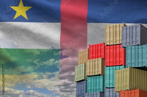 Central African Republic flag and big stack of shipping cargo containers in docks with sky background close up photo