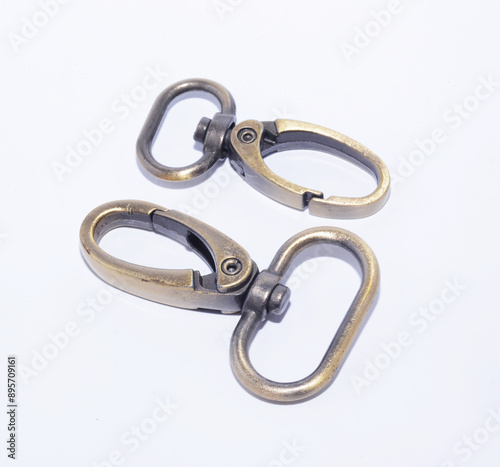 Brass lobster claw clasp or swivel hooks isolated on white. photo