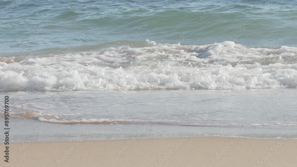 waves breaking on the shore on a fine sand beach waves breaking on the shore on a fine sand beach