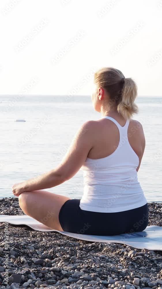 A happy relaxed woman breathing fresh air. A meditating woman who dreams of freedom and travel. A girl against the background of dawn, blue sky and sea. Summer lifestyle background. A happy relaxed woman breathing fresh air. A meditating woman who dreams of freedom and travel. A girl against the background of dawn, blue sky and sea. Summer lifestyle background.