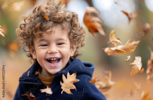 Boy Laughing in Autumn Leaves