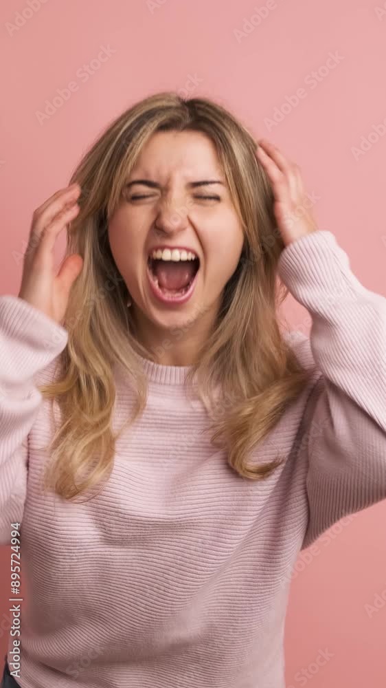Desperate woman yelling with eyes closed and hands on head Desperate woman yelling with eyes closed and hands on head
