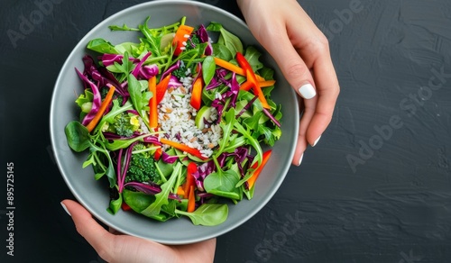 Hands Holding Bowl of Fresh Salad