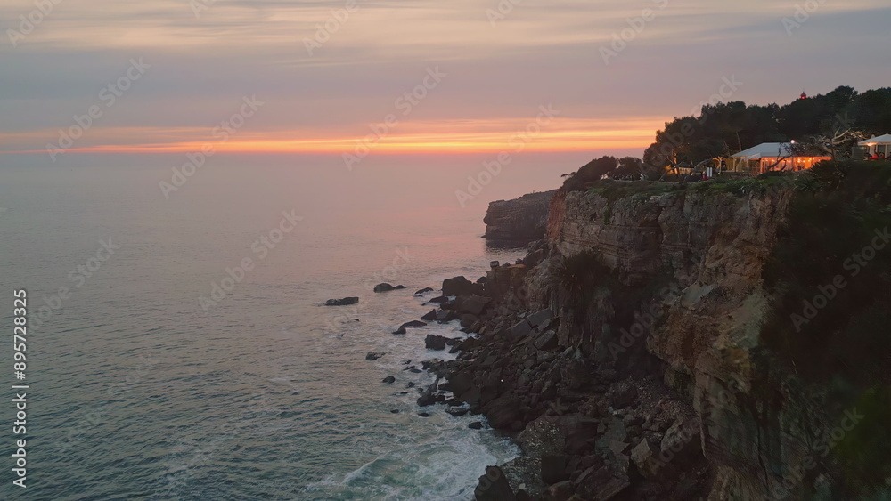 Coastal sunset foamy ocean splashing shore slow motion. Waves crashing cliffs Coastal sunset foamy ocean splashing shore slow motion. Waves crashing cliffs