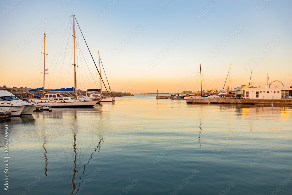 leisure yacht sailboats docked at small harbour in Cape Town at sunset leisure yacht sailboats docked at small harbour in Cape Town at sunset