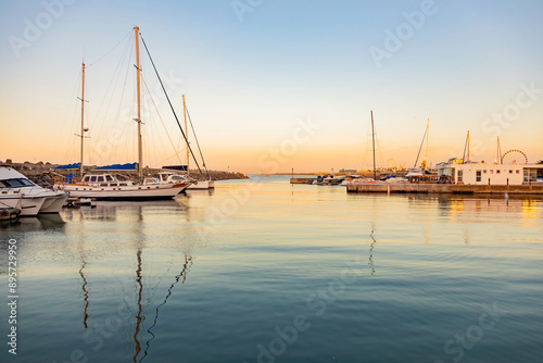 leisure yacht sailboats docked at small harbour in Cape Town at sunset
