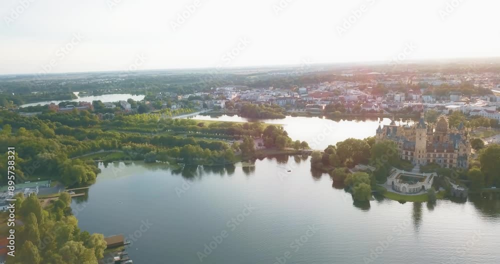 Amazing view over the lakes of Schwerin, historic castle with the Schlosspark in Germany at sunset, slow motion and copy space Amazing view over the lakes of Schwerin, historic castle with the Schlosspark in Germany at sunset, slow motion and copy space