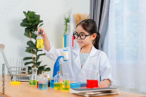 young Asia girl Scientist Conducting Experiment With Microscope In Laboratory