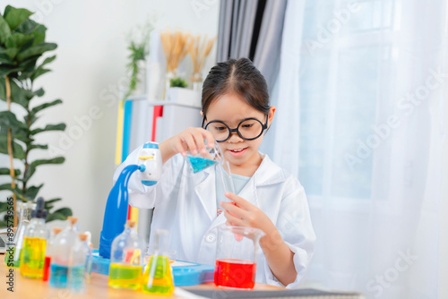 young Asia girl Scientist Conducting Experiment With Microscope In Laboratory