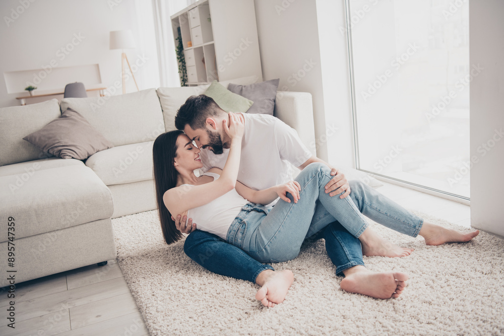 Full body photo of cheerful cute young couple enjoy weekend couple lying cuddle floor have fun playful buy new apartment indoors house home Full body photo of cheerful cute young couple enjoy weekend couple lying cuddle floor have fun playful buy new apartment indoors house home