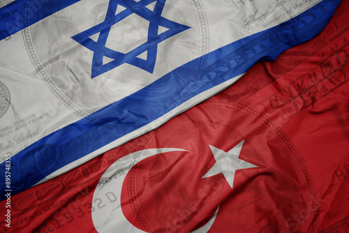Fototapeta Naklejka Na Ścianę i Meble -  waving colorful flag of israel and national flag of turkey on the dollar money background. finance concept.
