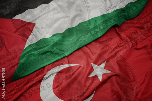 Fototapeta Naklejka Na Ścianę i Meble -  waving colorful flag of palestine and national flag of turkey on the dollar money background. finance concept.