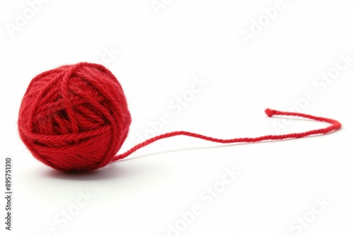 Photo of a red ball of wool against a white background. Knitwear and knitting concept.
