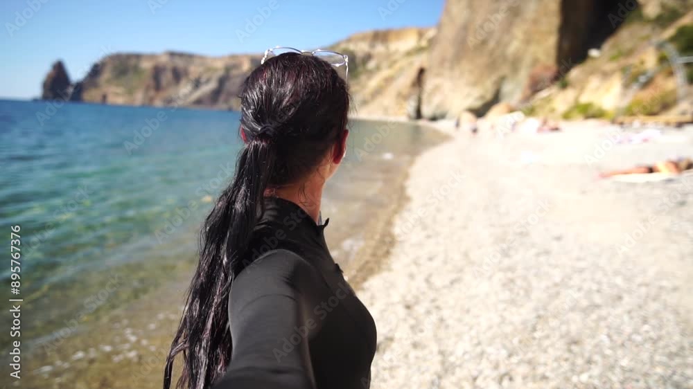Woman summer travel sea. Happy tourist enjoy taking selfie photo outdoors for memories. Woman traveler posing on the beach at sea surrounded by volcanic mountains, sharing travel adventure journey Woman summer travel sea. Happy tourist enjoy taking selfie photo outdoors for memories. Woman traveler posing on the beach at sea surrounded by volcanic mountains, sharing travel adventure journey